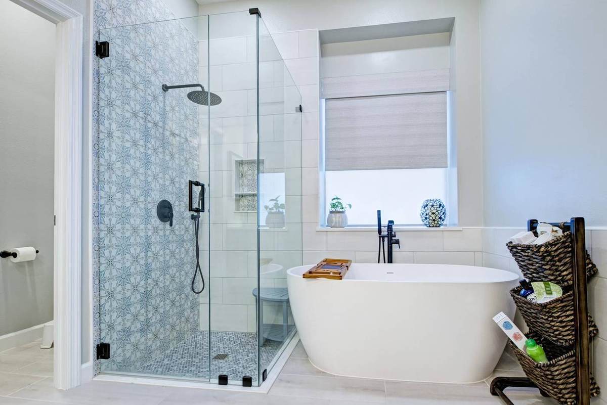 Master bathroom with Moroccan-pattern tile shower and freestanding tub